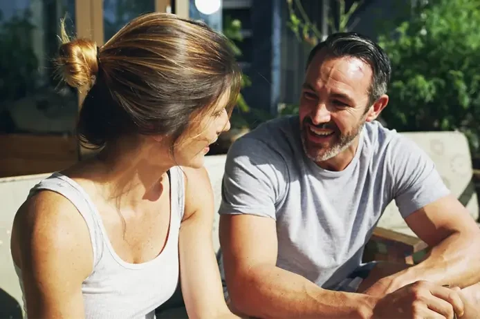 A couple laughing together outdoors